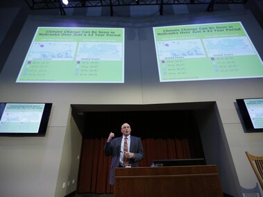 Dr. Robb Fraley on stage during his lecture.