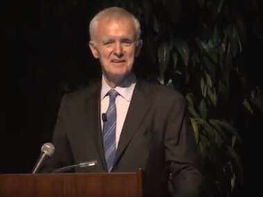 Bob Kerrey on stage during his lecture.