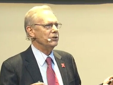 Donald Wilhite on stage during his lecture.